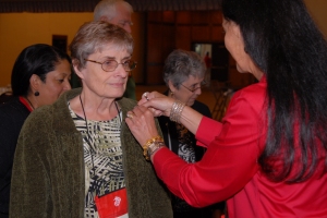 Tamara Fode pins the Vietnam Commemorative pin on Carol Mutter.